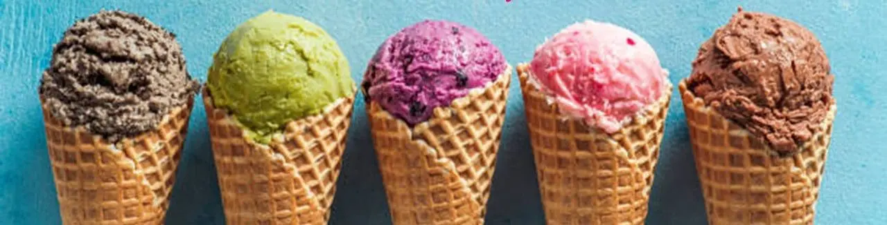 Colorful ice cream cones with various flavors, including green, pink, purple, brown, and gray, highlighting the offerings at the Poolside Ice Cream Social event at Gulf Waters Beach Front RV Resort.