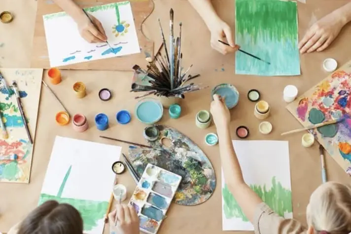Watercolor painting supplies and participants engaged in art creation during a watercolor art class at Gulf Waters Beach Front RV Resort.