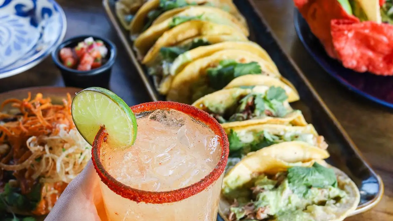 Tacos and margarita with lime garnish, featured for Cinco de Mayo Fiesta at Gulf Waters resort, showcasing festive food and drink offerings.