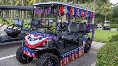 Colorful parade golf cart decorated with patriotic flags and streamers at Gulf Waters Resort.