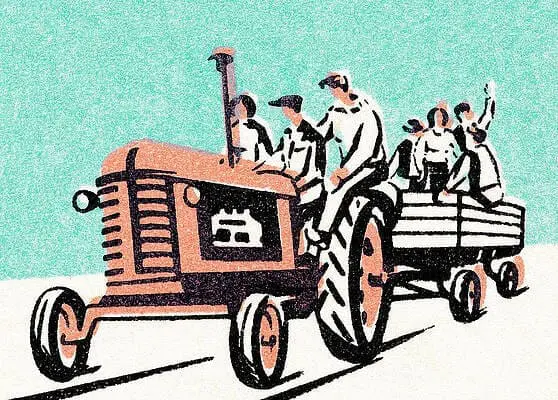 Tractor pulling a wagon with people, symbolizing the hayride event at Gulf Waters Beach Front RV Resort.