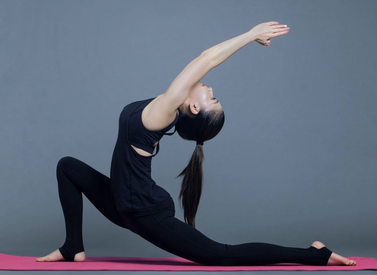 Woman practicing yoga on a mat at Gulf Waters Beach Front RV Resort.