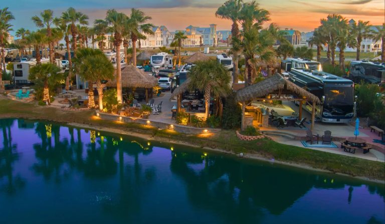 Beachfront RV resort with palm trees, pool, and RVs on Mustang Island.