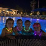 Children enjoying night swimming at Gulf Waters Beach Front RV Resort pool.