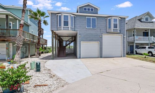 Beachfront RV resort home with elevated structure and garage parking.