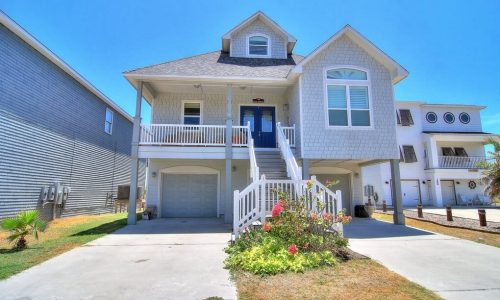 Beachfront house at Gulf Waters RV Resort with stairs and garden.
