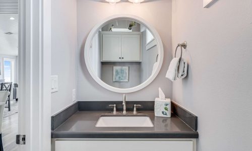 Modern bathroom at Gulf Waters Beach Front RV Resort with mirror and sink.