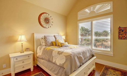 Cozy bedroom at Gulf Waters Beach Front RV Resort with large window and elegant decor.