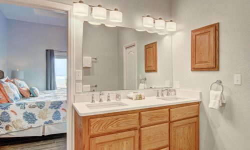 Modern bathroom at Gulf Waters Beach Front RV Resort with double sink and mirror.