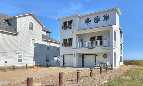 Modern beach house at Gulf Waters Beach Front RV Resort, featuring unique architecture, multiple balconies, and proximity to Mustang Island's sandy shores.