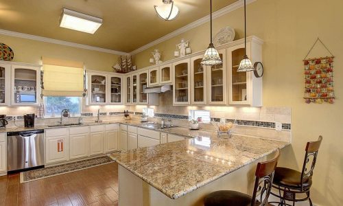 Spacious kitchen at Gulf Waters Beach Front RV Resort with modern appliances and granite countertops.