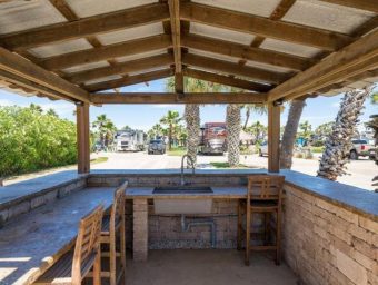 Beachfront bar area at Gulf Waters RV Resort with seating and scenic views.