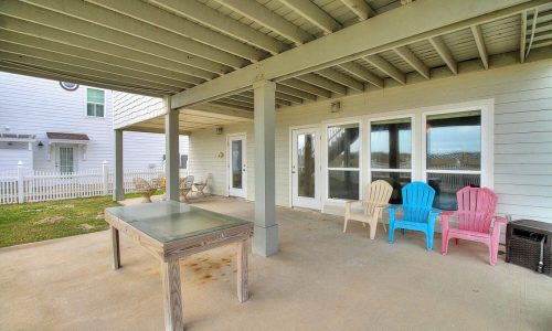 Covered patio with colorful chairs at Gulf Waters Beach Front RV Resort.