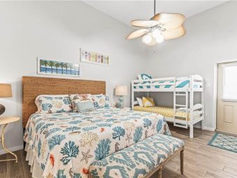 Beachfront bedroom with coastal decor and bunk beds at Gulf Waters RV Resort.