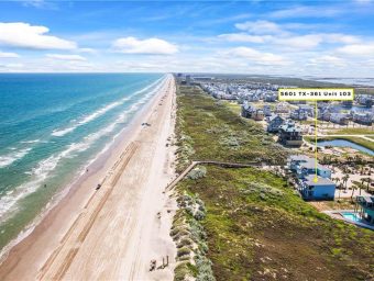 Beachfront RV lot at Gulf Waters with ocean view and nearby residential area.