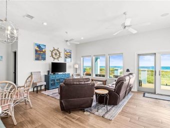 Bright living room with ocean view, comfortable furniture, and coastal decor at Gulf Waters.
