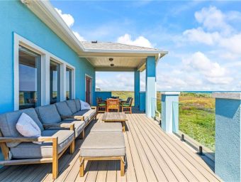 Beachfront deck at Gulf Waters RV Resort with outdoor seating and ocean view.