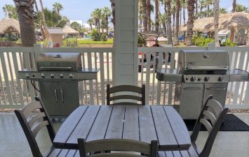 Outdoor grill area at Gulf Waters Beach Front RV Resort with table and chairs.