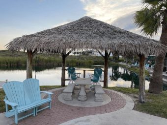 Beachfront gazebo with seating and water view at Gulf Waters RV Resort.