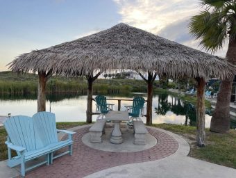 Beachfront gazebo with seating and water view at Gulf Waters RV Resort.