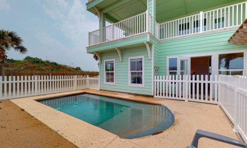 Beachfront villa at Gulf Waters RV Resort with pool and balcony.