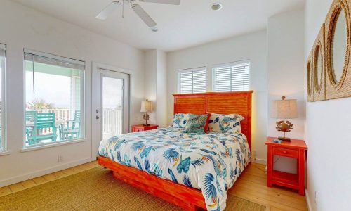 Bright bedroom with tropical decor and ocean view at Gulf Waters Beach Front RV Resort.