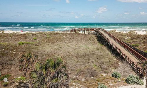 Scenic view of Gulf Waters Beach Front RV Resort with ocean and boardwalk.