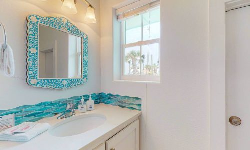 Bright bathroom with ocean view window at Gulf Waters Beach Front RV Resort.