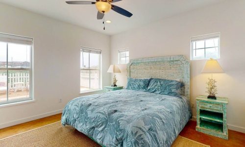 Bright bedroom with large windows and beach decor at Gulf Waters Beach Front RV Resort.