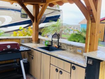 Outdoor kitchen at Gulf Waters Beach Front RV Resort with boat in background.